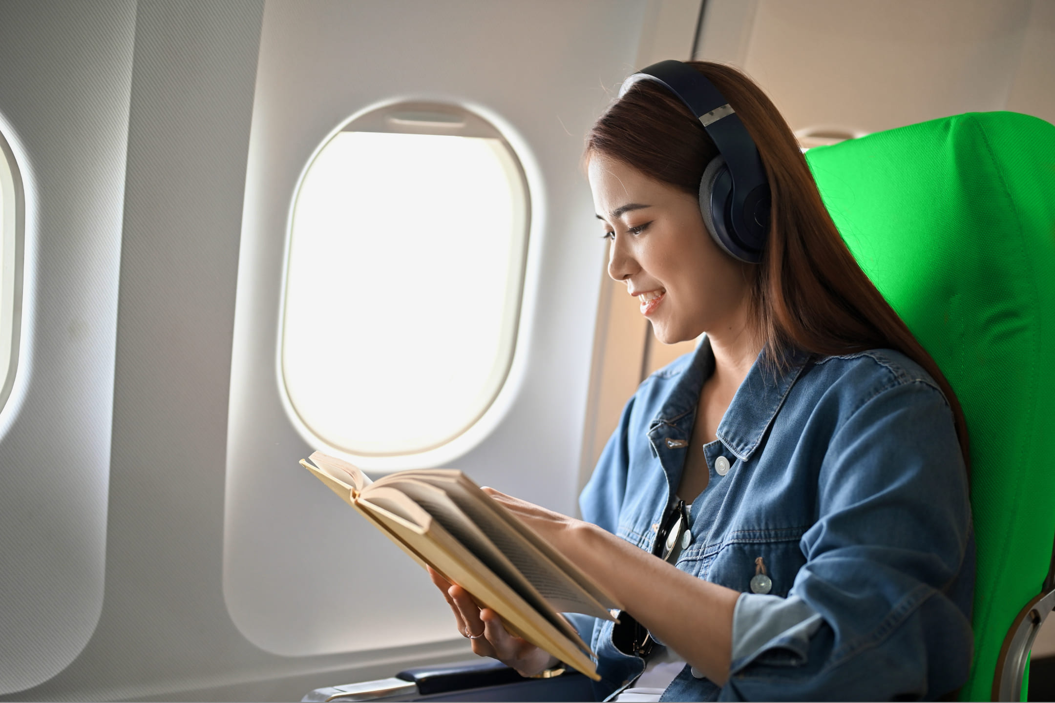 Девушка читает книгу в самолете